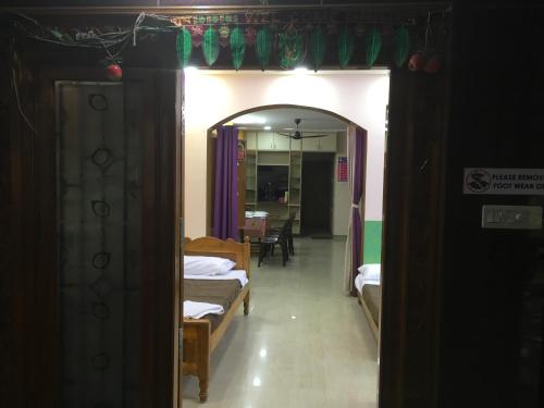 a room with a hallway with beds and a mirror at Jayaram Residency Tirupathi in Tirupati