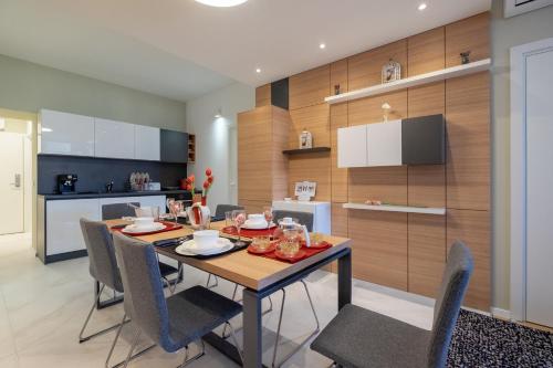 a kitchen and dining room with a table and chairs at Vitosha Blvd Luxury 2-Bedroom, 2-Bathroom with Balcony in Sofia