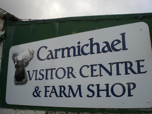a sign for a visitor center and farm shop at The Gardener's House in Covington