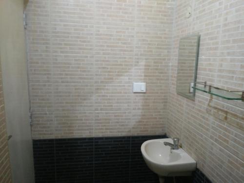 a bathroom with a sink and a mirror at ROYALE ACHAYA in Chennai