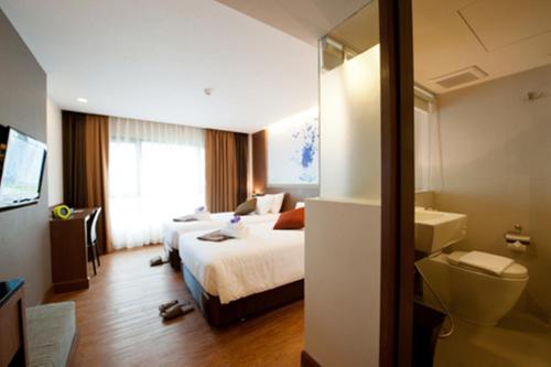 a hotel room with a bed and a bathroom at 41 Suite Bangkok in Bangkok