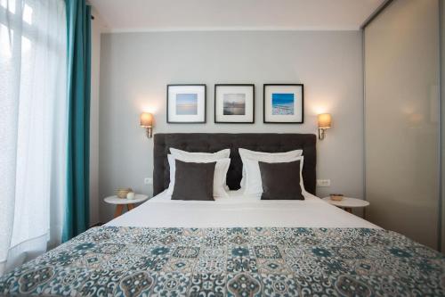 a bedroom with a large bed with pillows and two tables at Villa R&B in Sutivan