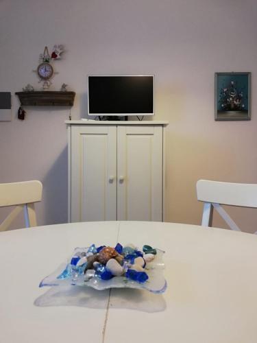 a cake on a table in a room with a tv at Blue Sea Apartment in Torre Canne