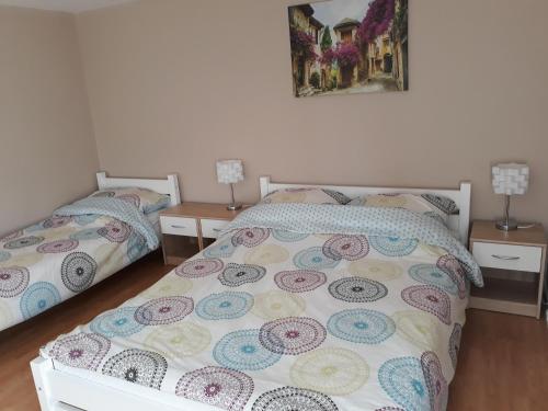a bedroom with two beds and two night stands at Agroturystyka Skrzeczówka in Krajno Pierwsze