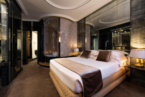 a hotel room with two beds and a large mirror at Atlante Star Hotel in Rome