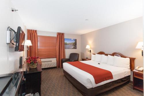 a hotel room with a bed and a television at The Niobrara Lodge in Valentine