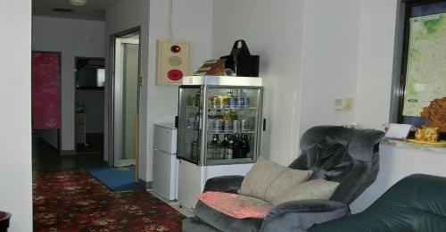 a living room with a chair and a refrigerator at Ryokan Suzukisou-10 tatami mats room No bath and toilet- Vacation STAY 17872 in Kyoto