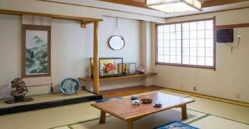 a living room with a table and a window at Ryokan Suzukisou-8 tatami mats room No bath and toilet- Vacation STAY 17864 in Kyoto