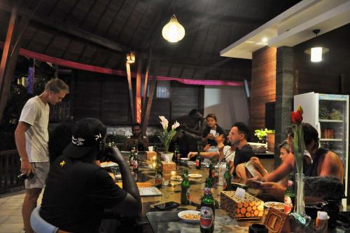 a group of people sitting around a long table at Ocean Terrace Suite And Spa Luxury in Nusa Penida