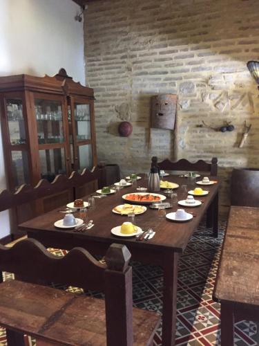 a wooden table with food on it in a room at Pousada São Pedro in Olinda