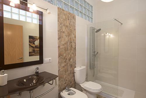a bathroom with a toilet and a sink and a shower at Villa Jazmin in Calpe