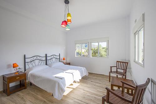 a bedroom with a bed and a table and chairs at Villa Jazmin in Calpe