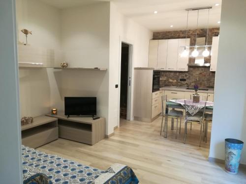 a kitchen and dining room with a table and a room with a dining room at Casa Anna in Moneglia