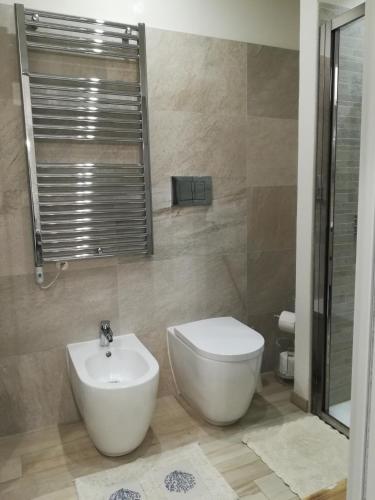 a bathroom with a toilet and a sink at Casa Anna in Moneglia