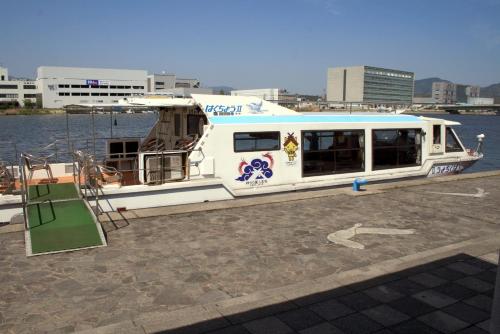 a white boat is parked on the water at Matsue Excel Hotel Tokyu in Matsue
