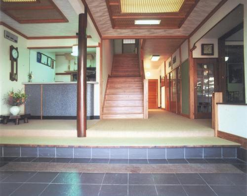 an empty lobby of a building with a staircase at Hinodeya in Ito