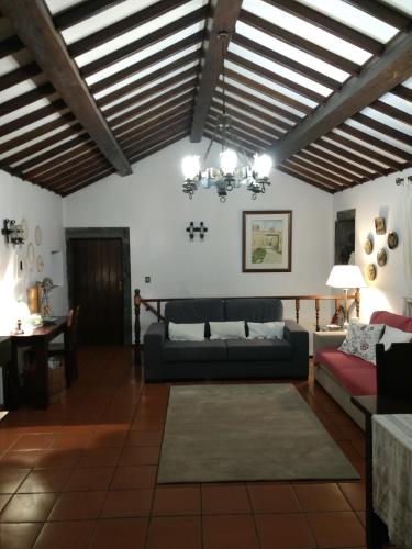 a living room with a couch and a table at Quinta dos Afectos in São Vicente Ferreira