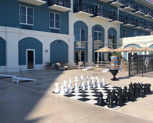 a giant chess board and chessetts on a sidewalk in front of a building at SEVEN Sebring Raceway Hotel in Sebring