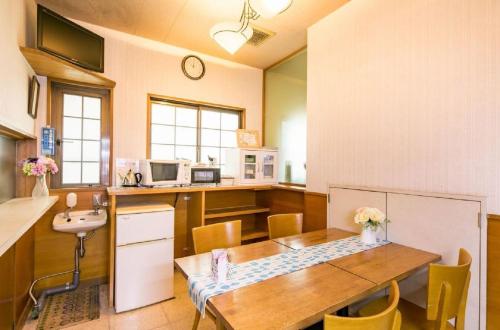a kitchen with a wooden table and a sink at Nagoya - Hotel / Vacation STAY 19141 in Nagoya