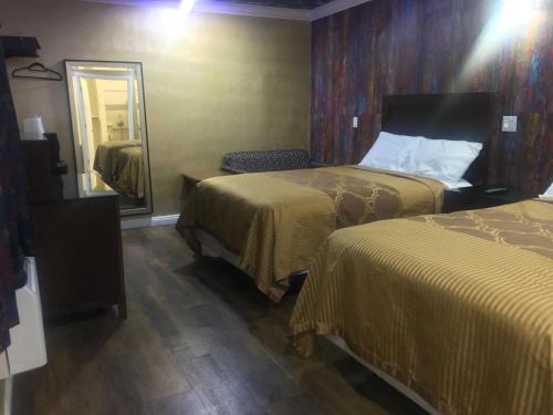 Letto o letti in una camera di Villa Park Motel
