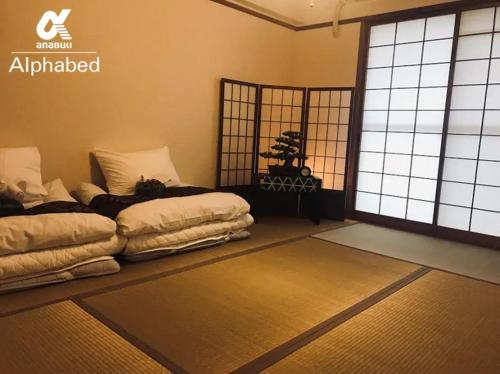 - 2 lits dans une chambre avec fenêtre dans l'établissement Alphabed Takamatsukouzaiekimae 102 / Vacation STAY 20340, à Takamatsu