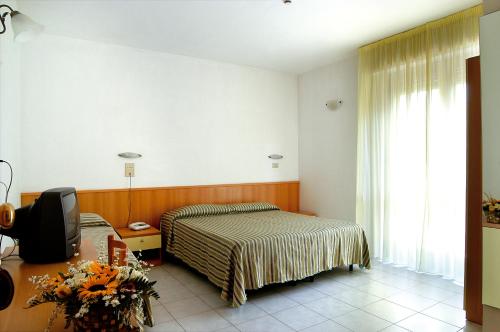Postel nebo postele na pokoji v ubytování Hotel Nel Pineto