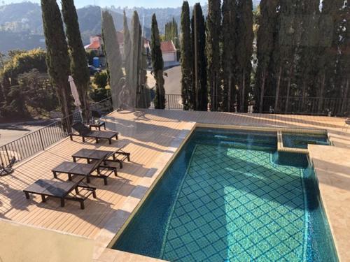 a swimming pool with two lounge chairs at Hollywood Hills private room in Los Angeles