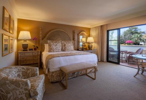 a bedroom with a large bed and a large window at Santa Barbara Inn in Santa Barbara