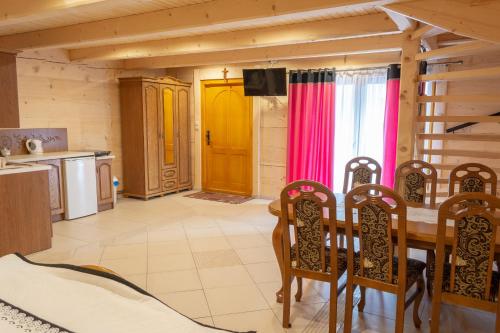 a kitchen with a table and chairs in a room at Leśny Dwór in Murzasichle
