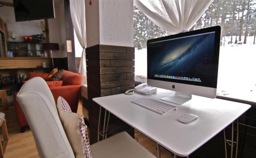 a white desk with a computer on top of it at Schanze Nozawa in Nozawa Onsen
