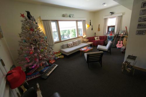 a living room with a christmas tree in it at Holiday Music Motel in Sturgeon Bay