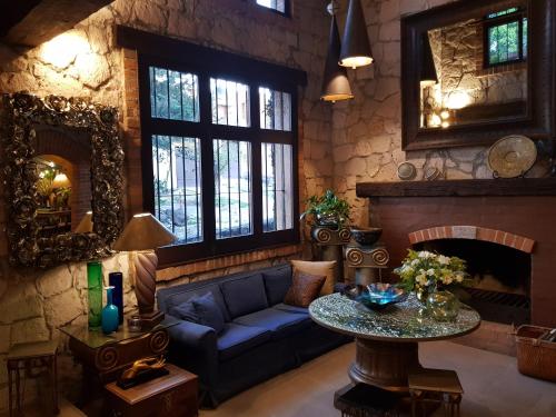 a living room with a blue couch and a table at Casa Aurea Hotel Boutique in Morelia