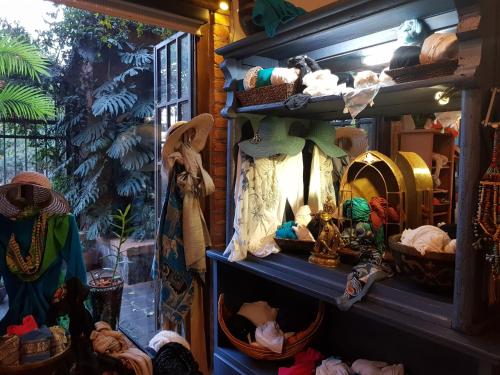 a shelf with hats and other items in a room at Casa Embrujo Morelia - Boutique in Morelia