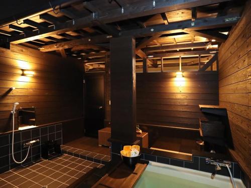 a bathroom with a bath tub and a sink at Hotel Nagasaki in Nagasaki