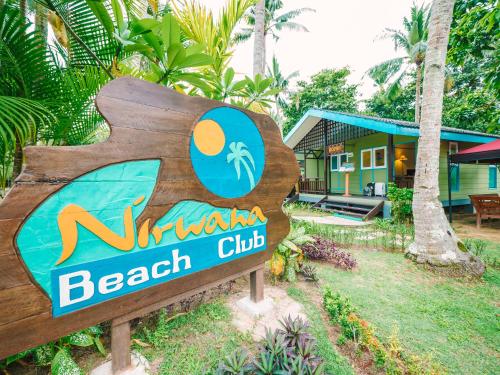 a sign for a beach club in front of a house at Nirwana Beach Club in Lagoi
