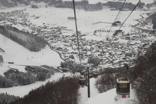 a ski lift in the snow with a crowd of people at Schanze Nozawa in Nozawa Onsen