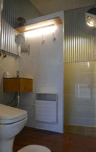 a bathroom with a white toilet and a shower at 양철지붕위의 고양이Cat on a Hot Tin Roof in Yangyang