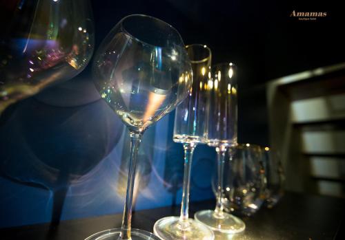 a group of wine glasses sitting on a table at Amamas Boutique Hotel Kuching in Kuching