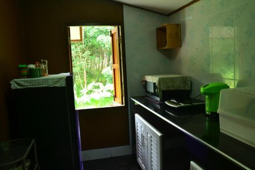 a kitchen with a sink and a window in it at Bang Hon Homestay in Ko Yao Noi