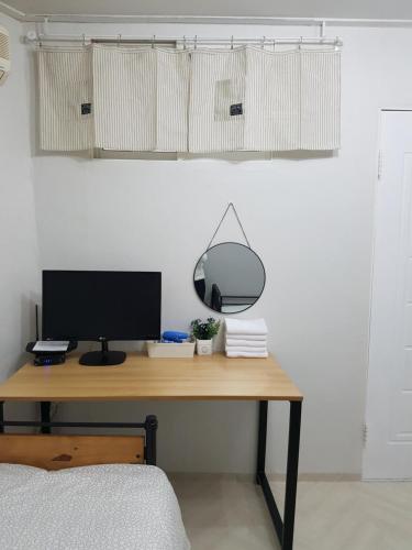 a desk with a computer and a mirror on it at Y.ROAD 135 in Seoul
