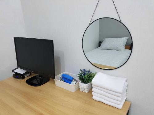 a mirror on a desk with a computer and a monitor at Y.ROAD 135 in Seoul