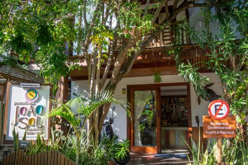 a building with a no parking sign in front of it at Pousada João Sol in Praia do Forte