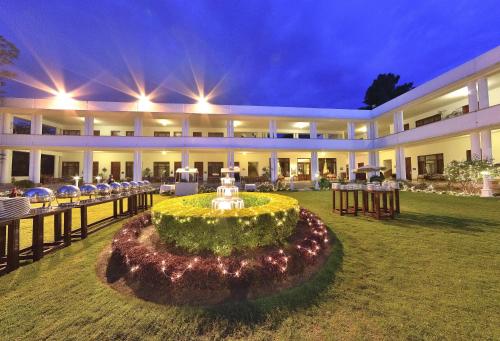a large building with a garden in front of it at Swat Serena Hotel in Saidu