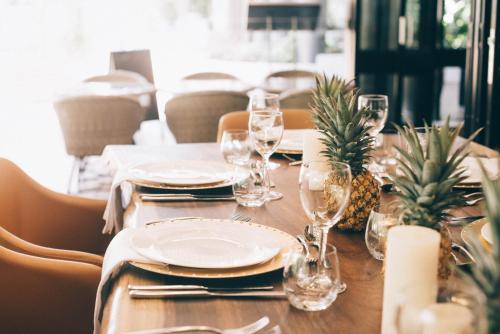 a table with plates and wine glasses on it at Mantra Club Croc in Airlie Beach
