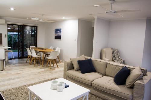 a living room with a couch and a table at Wellington Parade 15a Shelly Beach Caloundra in Caloundra
