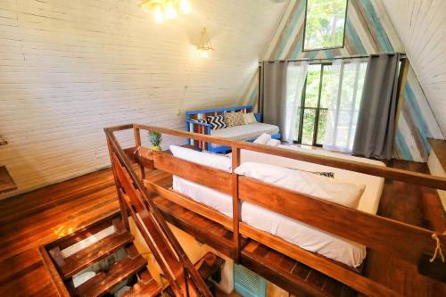 a room with three bunk beds in a house at Calala Lodge in Cabuya