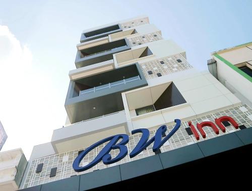 a building with a large blue sign on it at BW inn Belitung in Tanjungpandan
