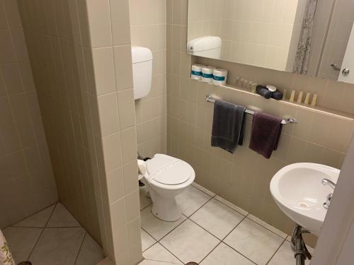 a bathroom with a toilet and a sink at The Stuart Hotel-Motel in Katherine