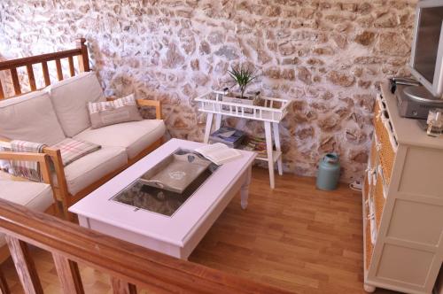 a living room with a couch and a table at la Ferme aux abeilles in Ambierle