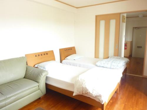 Ένα ή περισσότερα κρεβάτια σε δωμάτιο στο Ocean Front Miyakojima